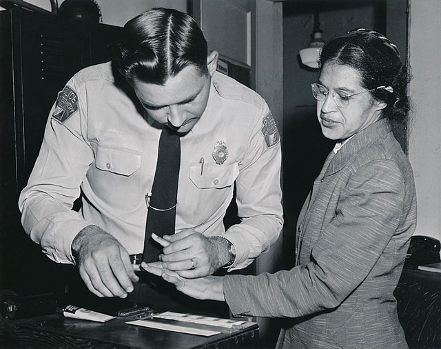 Rosa Parks being fingerprinted by Deputy Sheriff D.H. Lackey after being arrested on February 22, 1956, during the Montgomery bus boycott